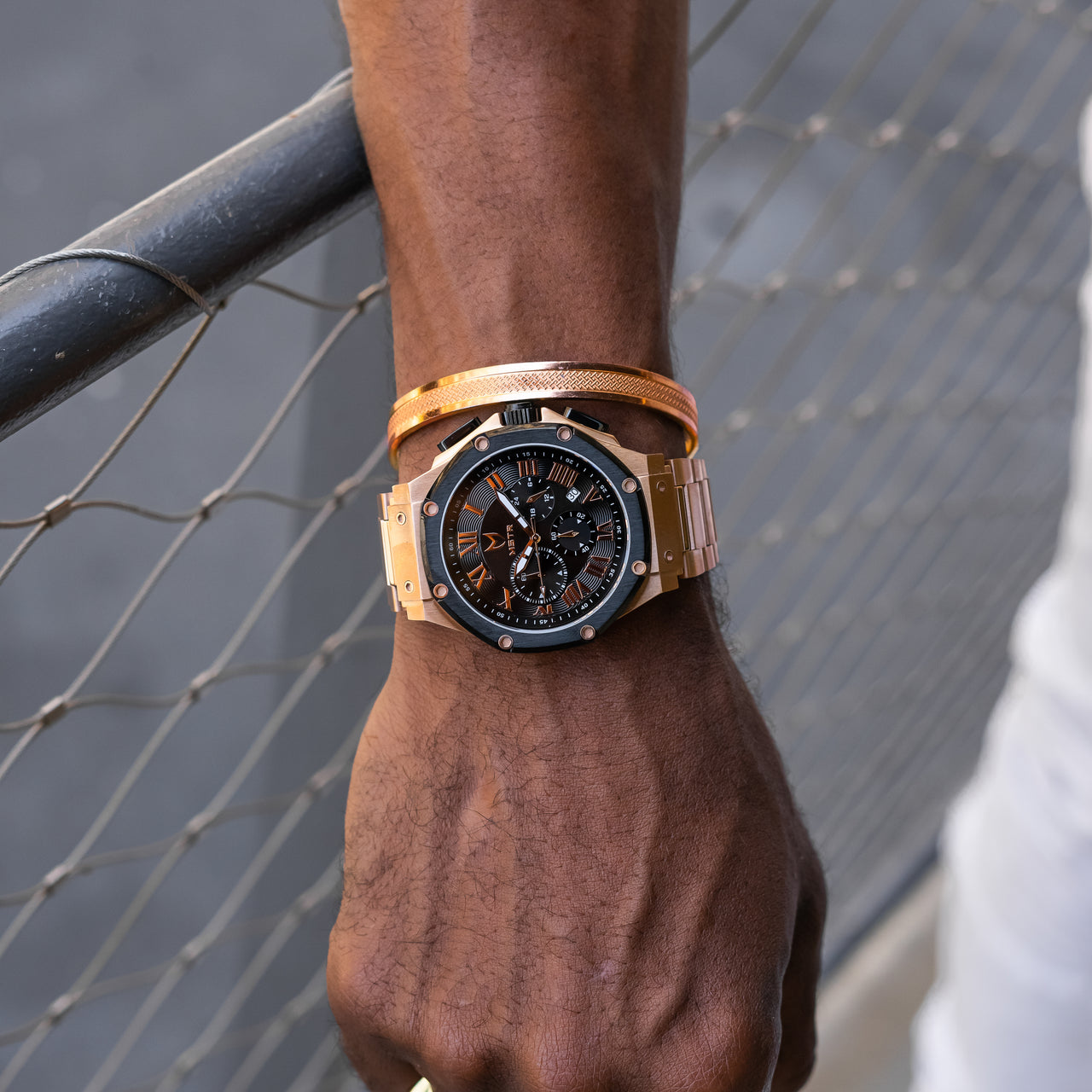 MSTR Ambassador 139SS Rose gold and black watch on models wrist