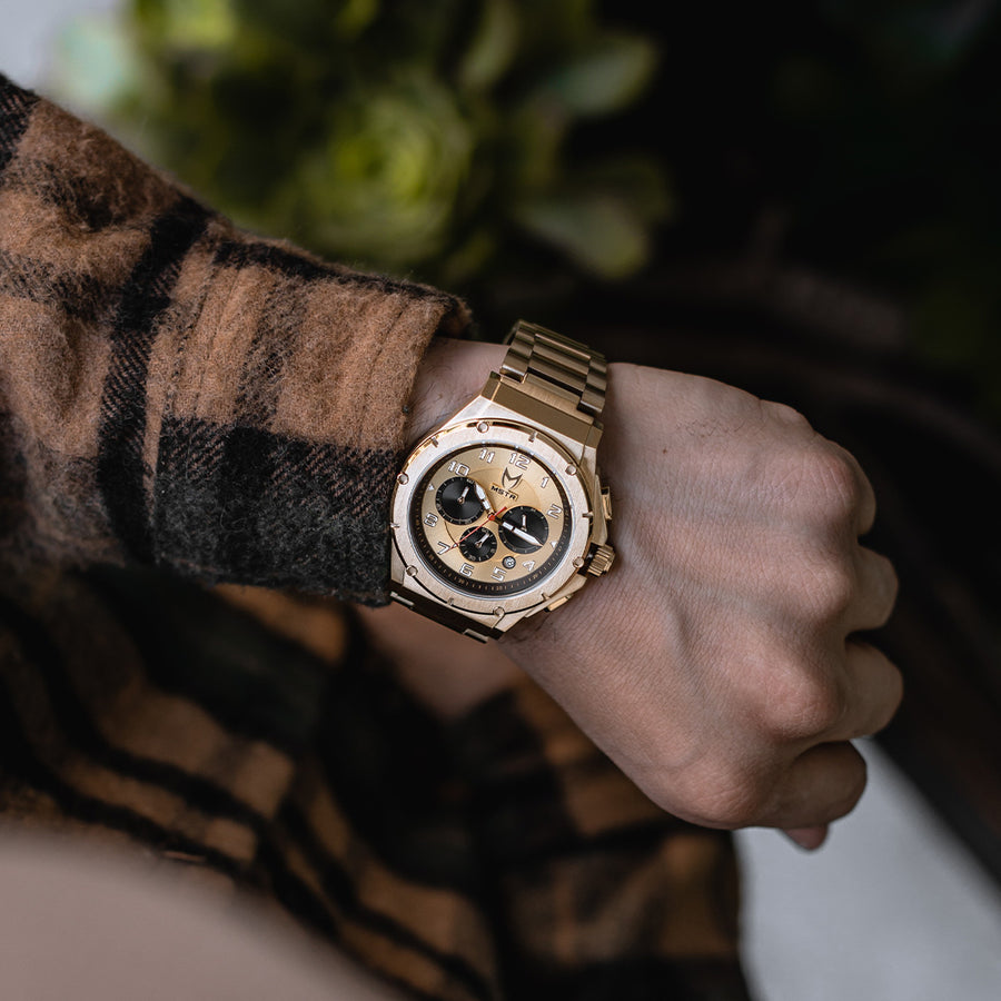 gold watch on wrist